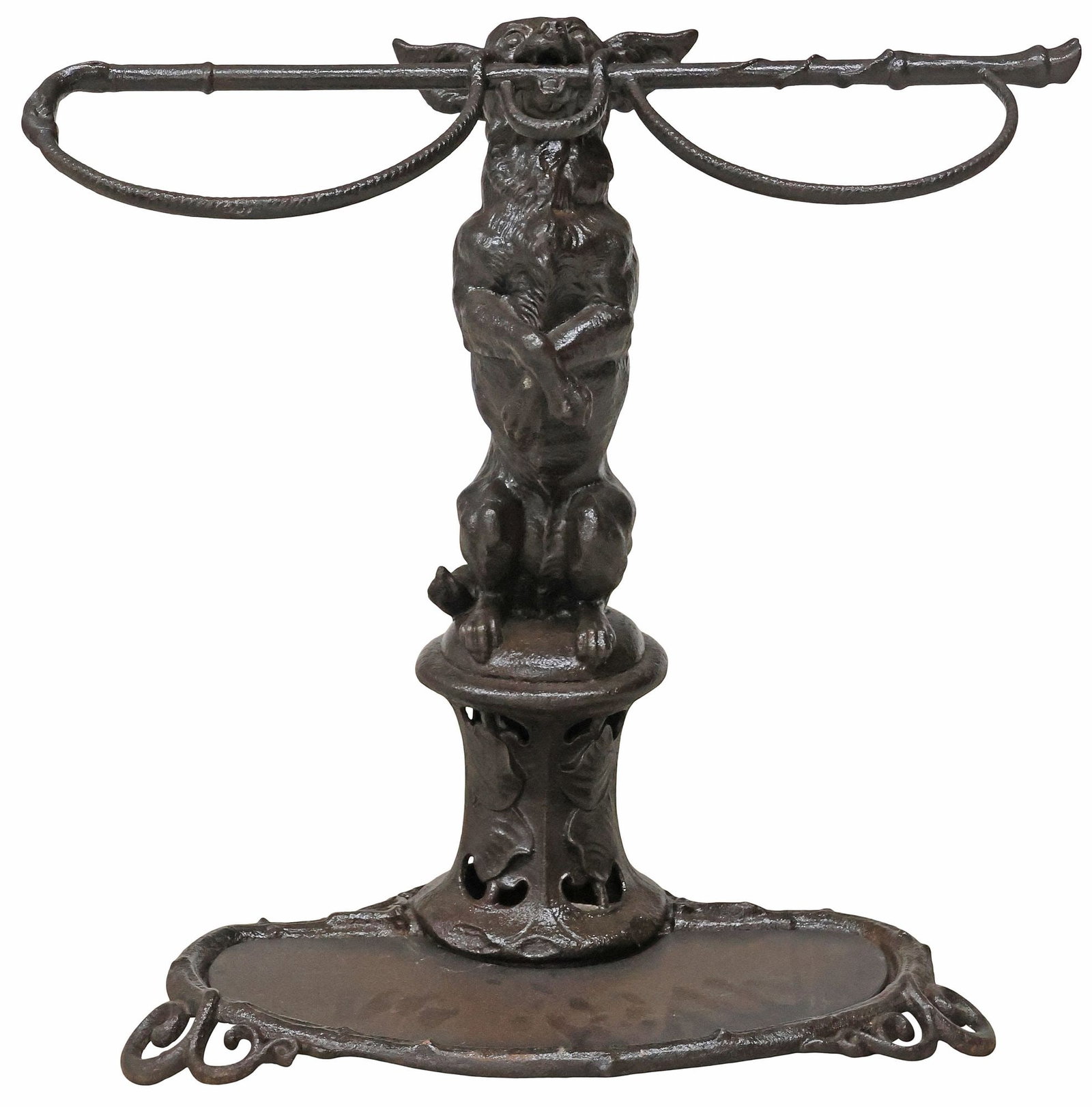 ENGLISH VICTORIAN COALBROOKDALE (ATTRIB.) CAST IRON STICK / UMBRELLA STAND: English Victorian cast iron umbrella/ stick stand, attributed to Coalbrookdale, Shropshite, late 19th c., modeled as a chihuahua gripping a riding crop in the mouth, standing atop a pierced pedestal b