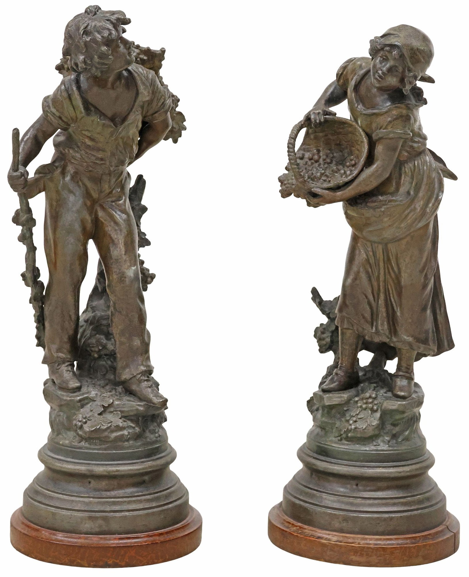 (2) STYLE OF L. & F. MOREAU SPELTER SCULPTURES, GRAPE HARVESTERS: (pair) Cast spelter figures, Grape Harvesters, in the manner of Louis Auguste Moreau (French, 1834-1917) and Hippolyte Francois Moreau (French, 1932-1927), depicting a boy with a walking stick carryin