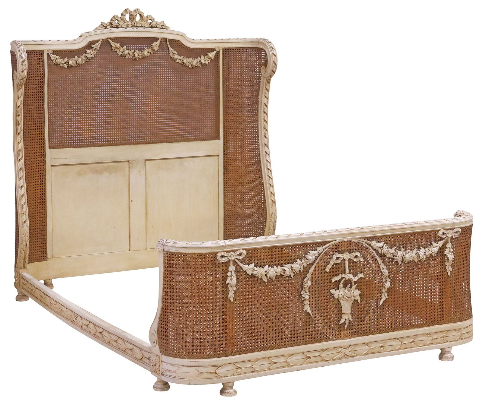 FRENCH LOUIS XVI STYLE PAINTED & DOUBLE-CANED BED: French Louis XVI style white-painted bed, early 20th c., having molded ribbon bow crest, double-caned head and foot boards overlaid with floral swags, joined by side rails with ribbon-bound foliates, 