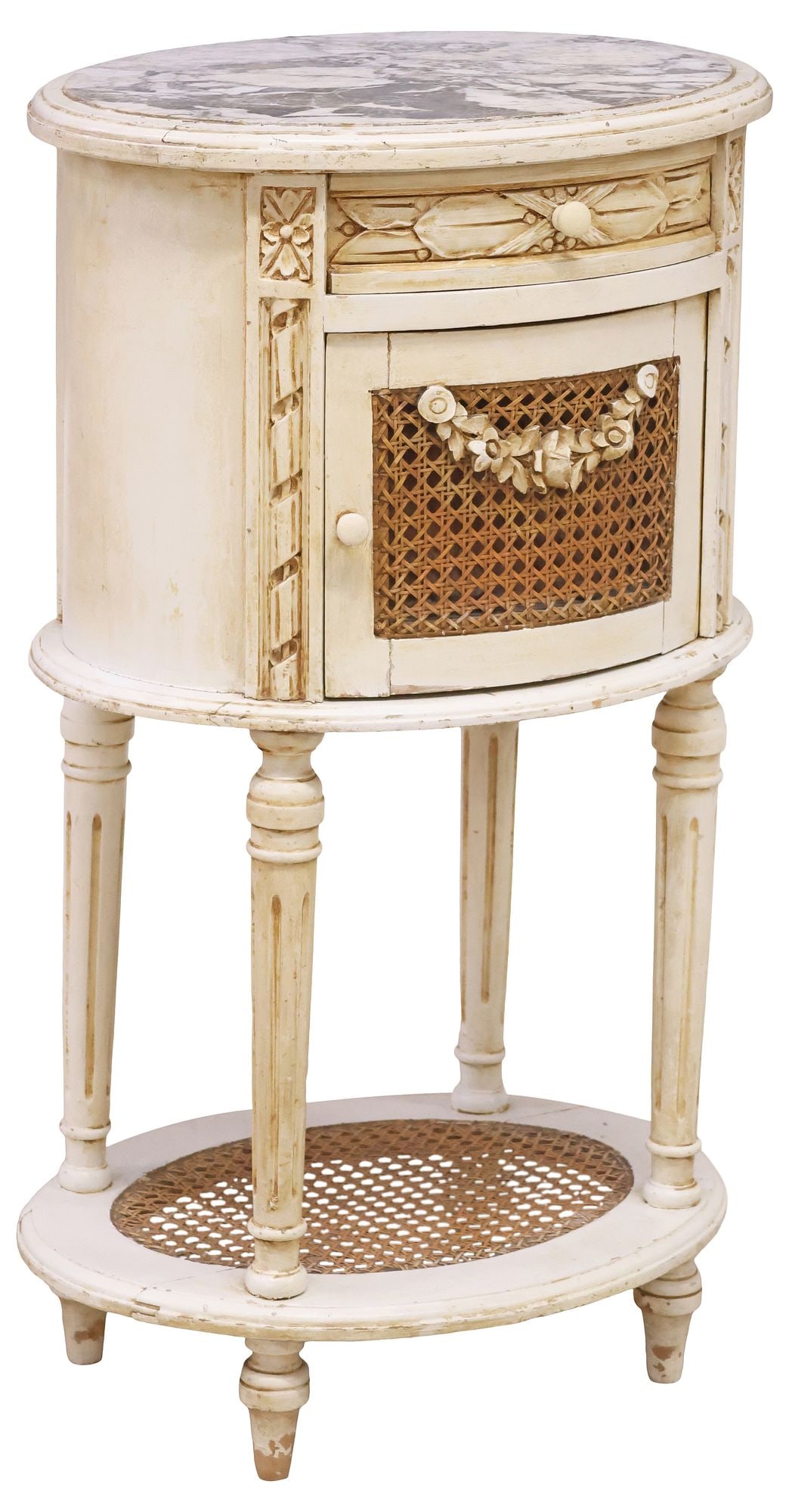FRENCH LOUIS XVI STYLE MARBLE-TOP CANED & PAINTED BEDSIDE CABINET: French Louis XVI style paint-decorated nightstand, early 20th c., in a white and cream painted finish, inset marble top, over single drawer, and caned cabinet door with floral swag, rising on tapering