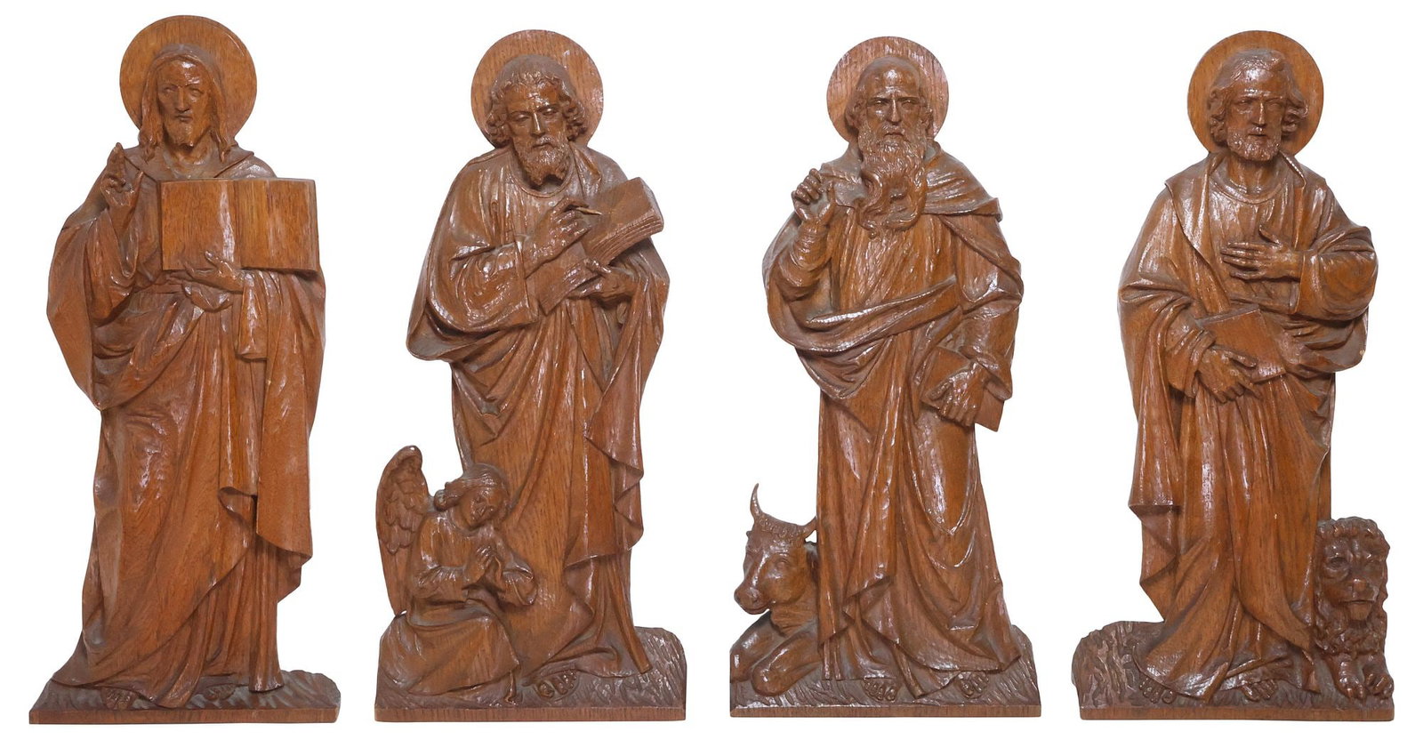 (4) LARGE CARVED OAK RELIGIOUS RELIEF SCULPTURES, THE FOUR EVANGELISTS: (lot of 4) Carved oak religious wall-mounted relief sculptures, The Four Evangelists, late 19th c., depicting the Biblical figures Mark, Matthew, Luke, and John with iconographical elements, slightly 