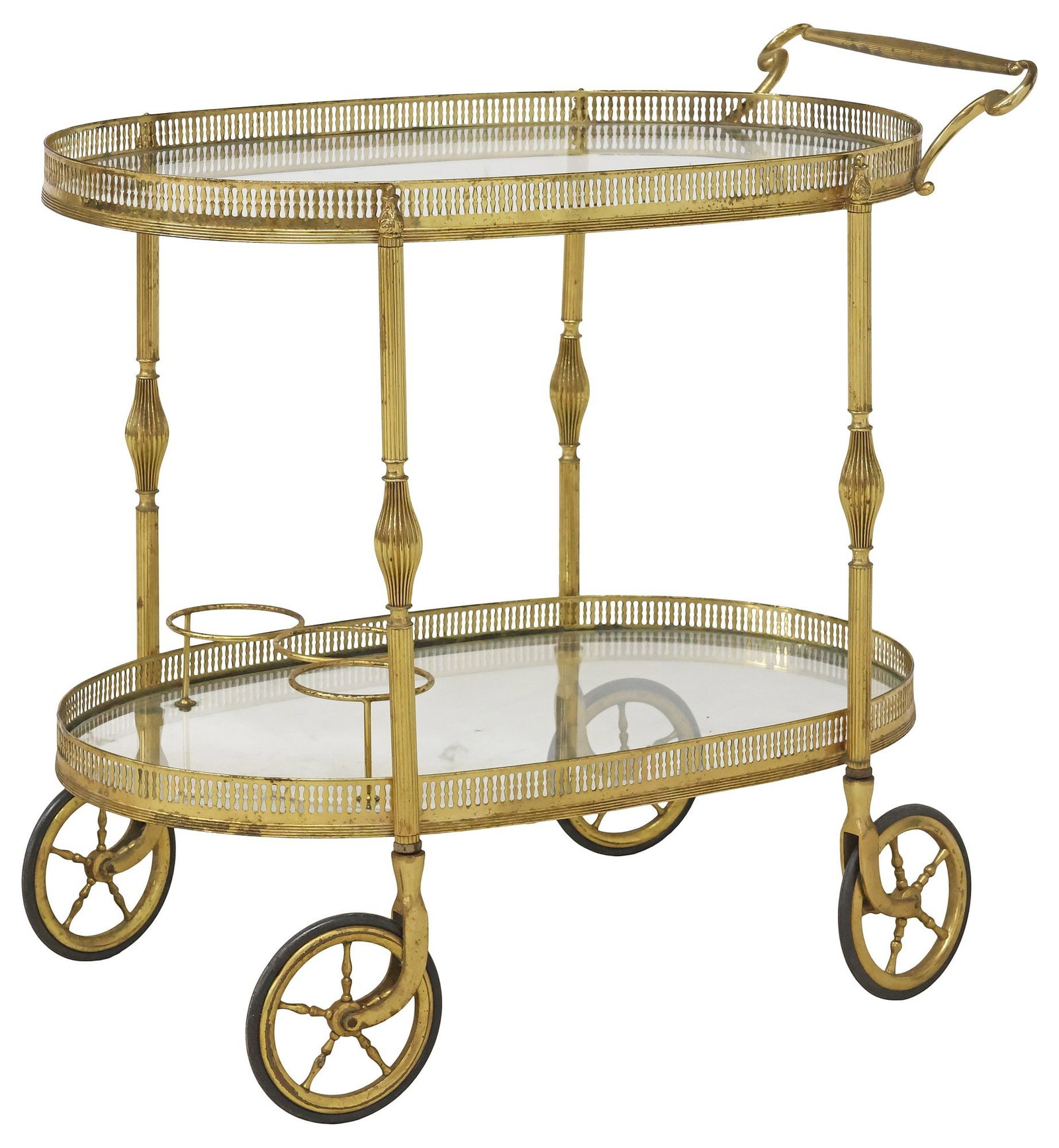 ITALIAN BRASS & GLASS TWO-TIER SERVICE CART: Italian brass service trolley/ bar cart, 20th c., comprising two colorless glass tiers with pierced gallery, lower tier with three-ring bottle rack, reeded supports ending on spoked wheels, approx 28.