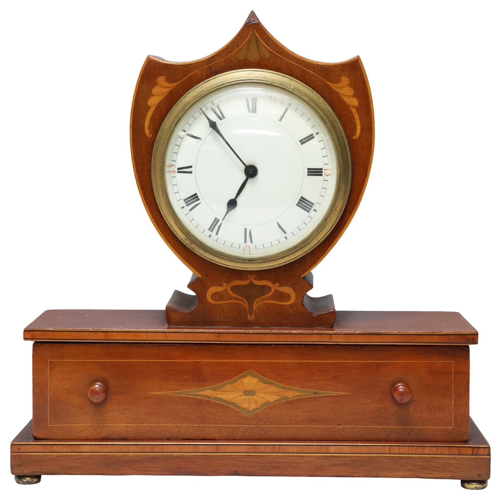 ENGLISH EDWARDIAN INLAID MAHOGANY SHIELD-CASE MANTEL CLOCK: English Edwardian inlaid mahogany mantle clock, early 20th c., shield-form case with foliate marquetry and stringwork trim, centering white dial with Roman numeral hour markers, time-only movement, ri
