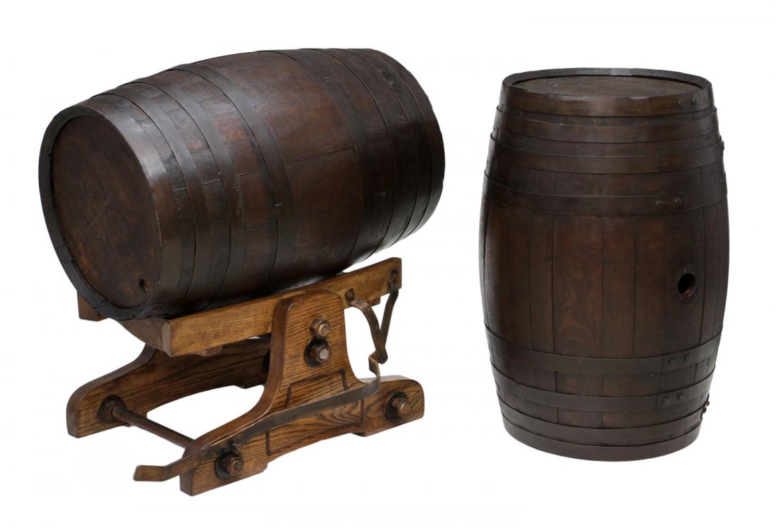 (3) VINTAGE OAK WINE BARRELS & TILTING CRADLE: (lot of 3) Two metal band bound oak wine barrels together with a tilting cradle, barrels: 29.5"h, 19"d, tilting cradle: 14"h, 30"w, 18"d **Provenance: The Richard Allen Garriott de Cayeux (Cambridge, 
