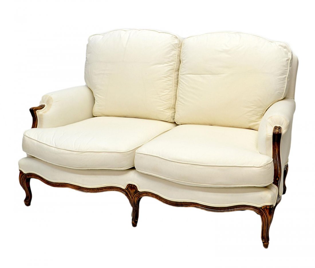 VERY FINE FRENCH PROVINCIAL UPHOLSTERED SOFA: French Provincial upholstered settee, 19th c., loose cushions on the back and deep seat, carved frame rising on short cabriole supports, ending in scrolled toes, upholstery in need of cleaning, some s