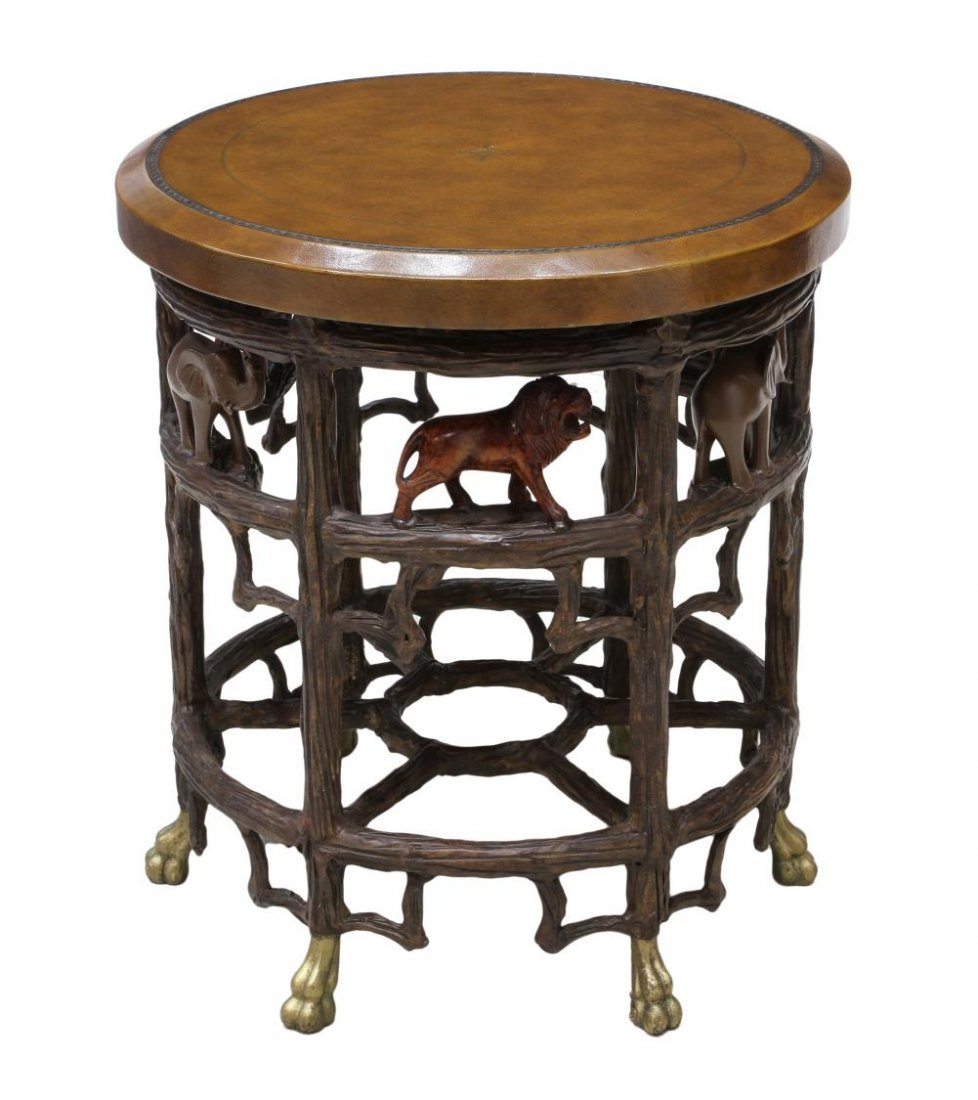 LEATHER TOP LAMP TABLE, LIONS & ELEPHANTS: Designer leather top circular lamp table having tree form open steel base with lions and elephants, rising on claw feet, 27.5"h, 24.5"d Start Price: $200.00