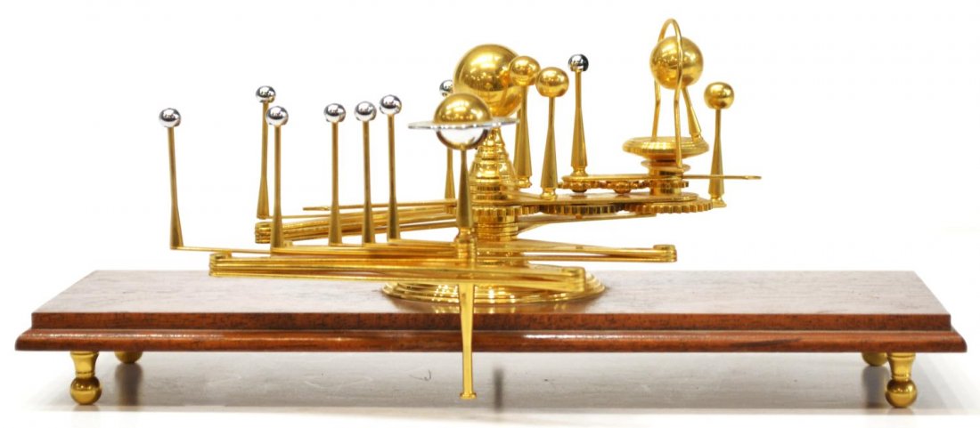 VAN CORT ORRERY, PLANETARIUM: Brass orrery by "Van Cort Instrument Makers", mounted on wood stand, based on an 18th century model, six planets represented at one side, manually gear operated earth around the sun, extends to 33", c