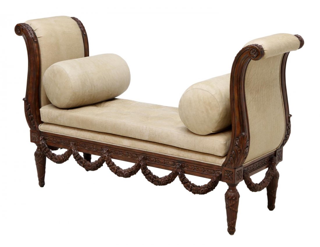 MAITLAND-SMITH LEATHER UPHOLSTERED CARVED BENCH: Maitland-Smith Louis XVI style end of bed bench, late 20th c., scrolled high ends between the leather upholstered seat with two matching bolster pillows, the frame with draped carved wood garlands ris