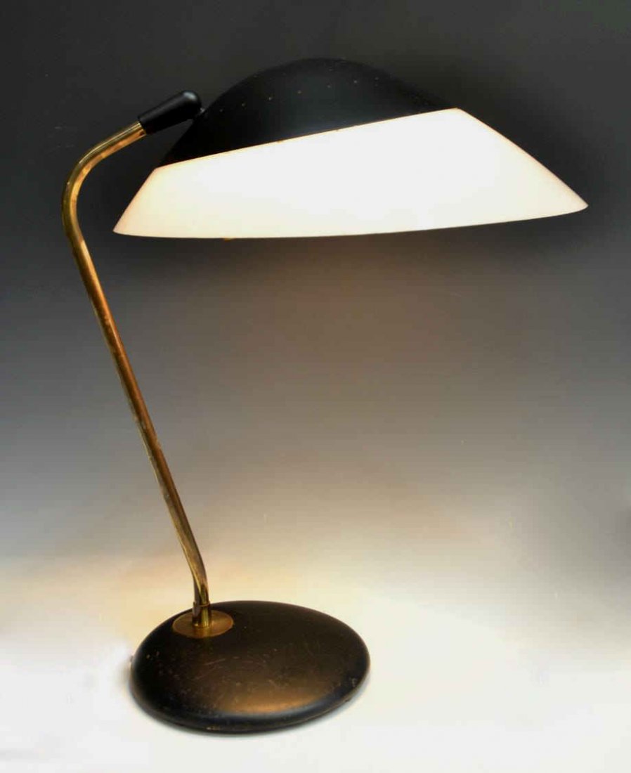 AMERICAN LIGHTOLIER MID-CENTURY TABLE LAMP: American mid-century table lamp, Lightolier, black enameled metal base of circular form, supporting a cylindrical stem, white plastic shade with black dome, scratches to base, working order at this ti