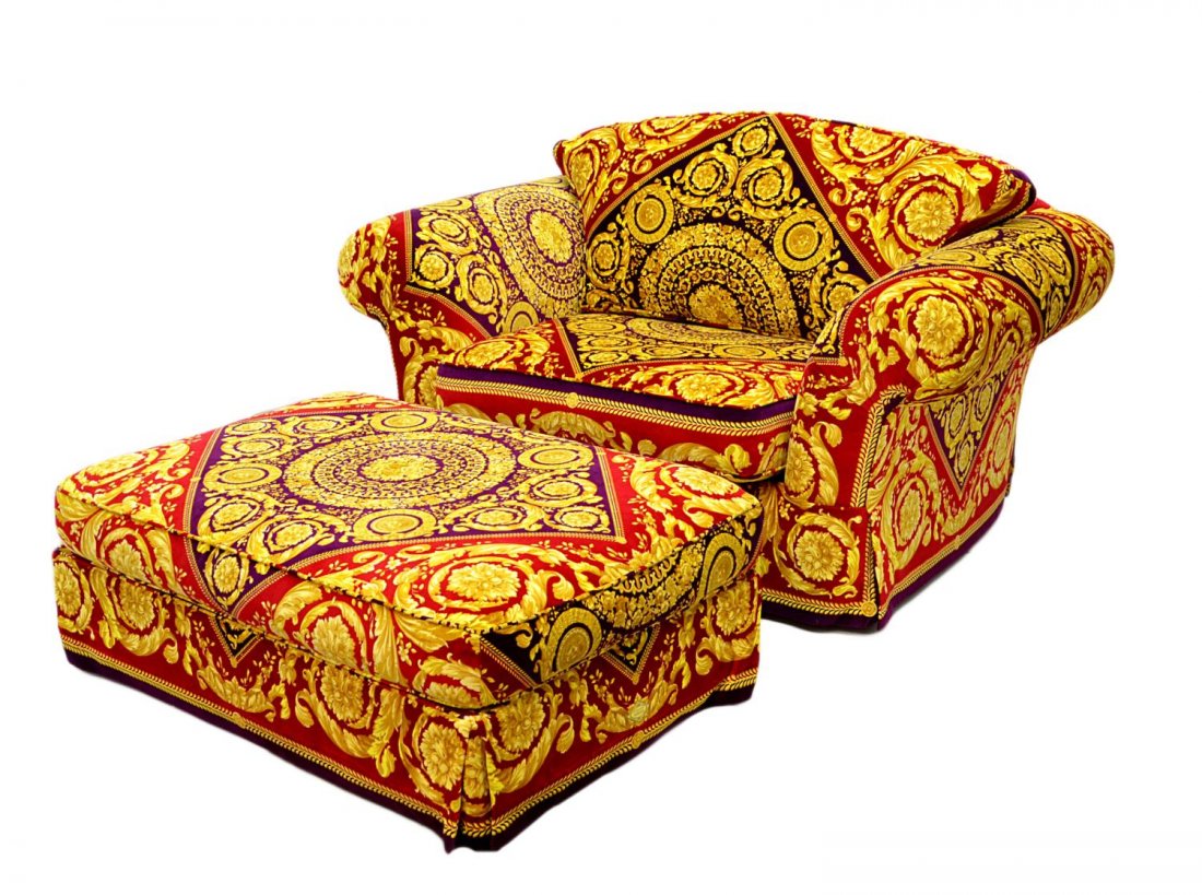 LARGE VERSACE FABRIC UNHOLSTERED CHAIR & OTTOMAN: (lot of 2) Oversize armchair and ottoman reupholstered with Versace red, black and gold foliate fabric, ottoman: 16"h, 46"w, 31"d, chair: 34"h, 58.5"w, 40"d Start Price: $750.00