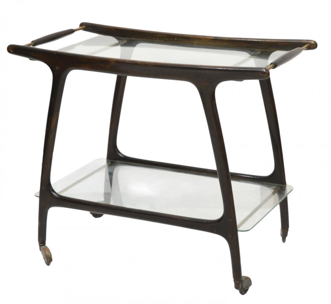 MID-CENTURY ITALIAN DESIGN SERVICE CART / TROLLEY: Italian design service trolley, c. 1960's, the shaped wood frame fitted with two glass shelves, handles to either side, the whole moving on castors, approx 26.5"h, 32"l, 17"w Start Price: $125.00