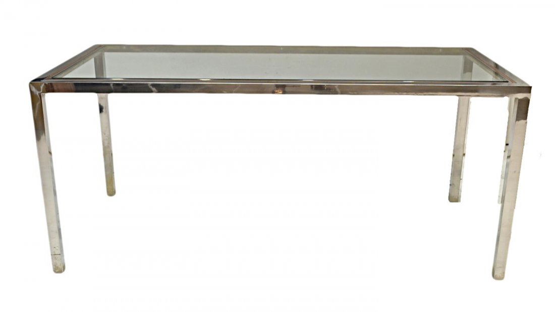 MODERN MAISEN JANSEN GLASS TOP METAL DINING TABLE: Modern dining table, design by Maison Jansen, c. 1970's, metal frame in a chrome finish set with a glass top, some surface wear, unmarked, approx 28"h, 65.25"l, 33.75"w Start Price: $300.00