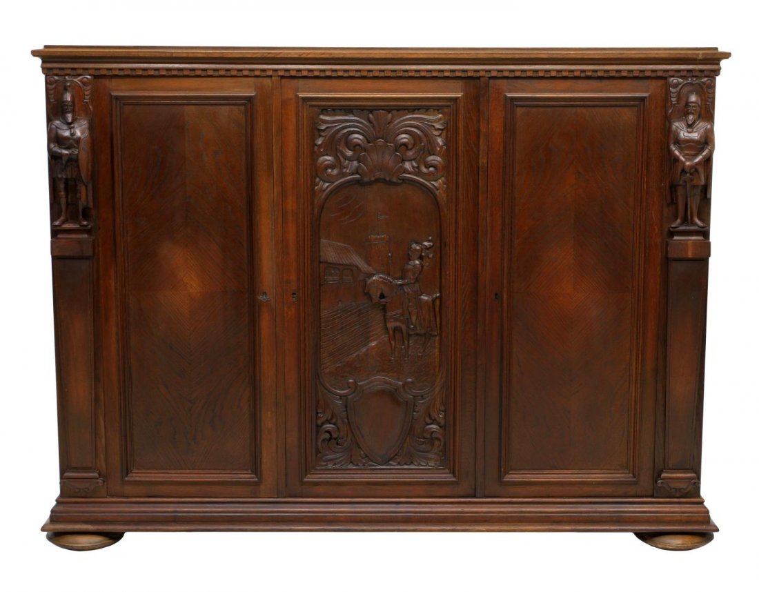 ANTIQUE DANISH CARVED OAK FIGURAL SIDEBOARD: Antique Danish carved oak sideboard, two side doors flanked by medieval soldiers opening to shelved storage, centering a carved panel with a shell form crest and scrolling foliage depicting a medieval
