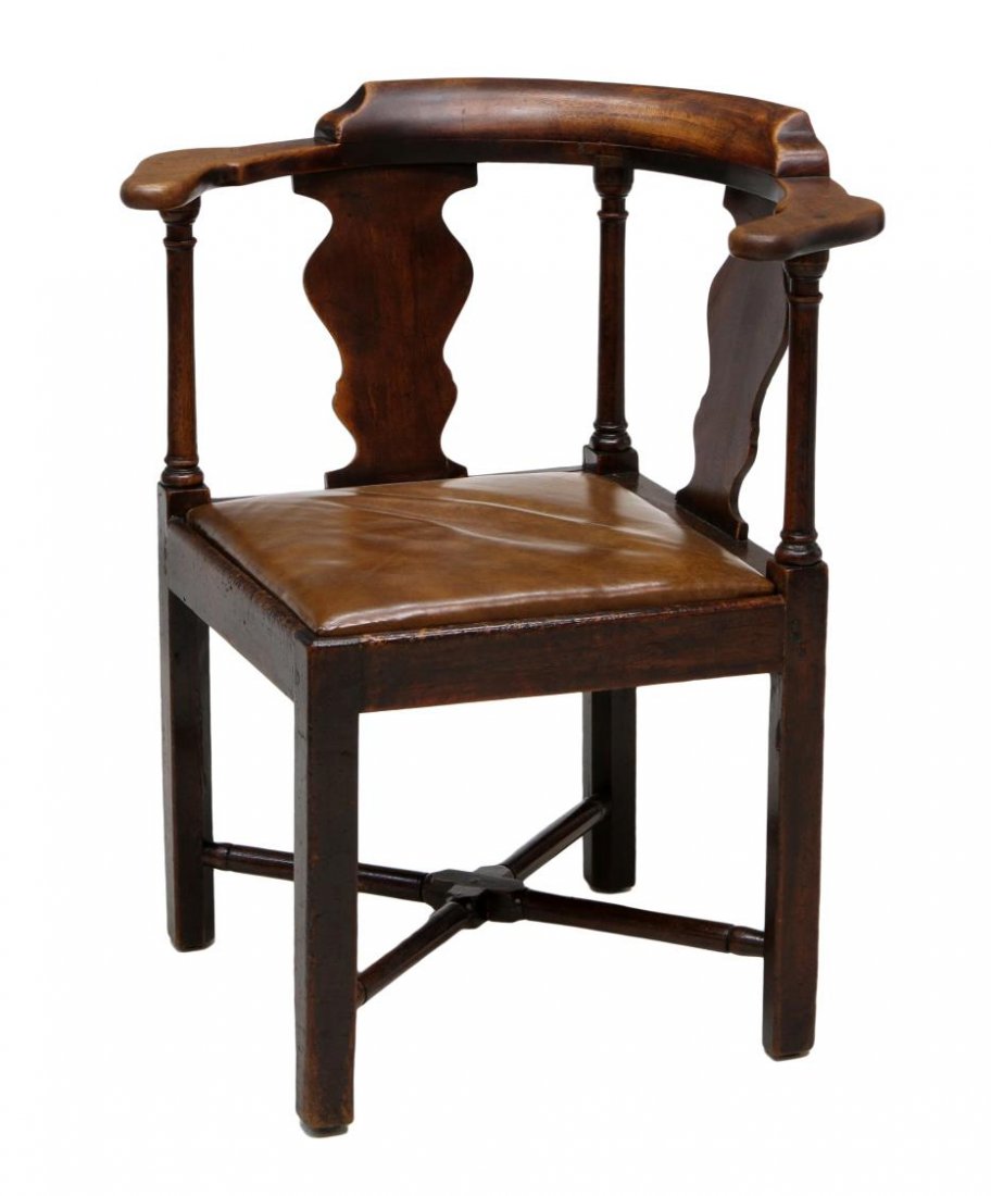 ENGLISH STYLE MAHOGANY & LEATHER CORNER CHAIR: English style carved mahogany corner chair, Guild Hall Cabinet Shops Ltd., Toronto, two vasiform back splats over the removable leather seat, on four legs joined by x-form stretchers, approx 32.5"h, 2