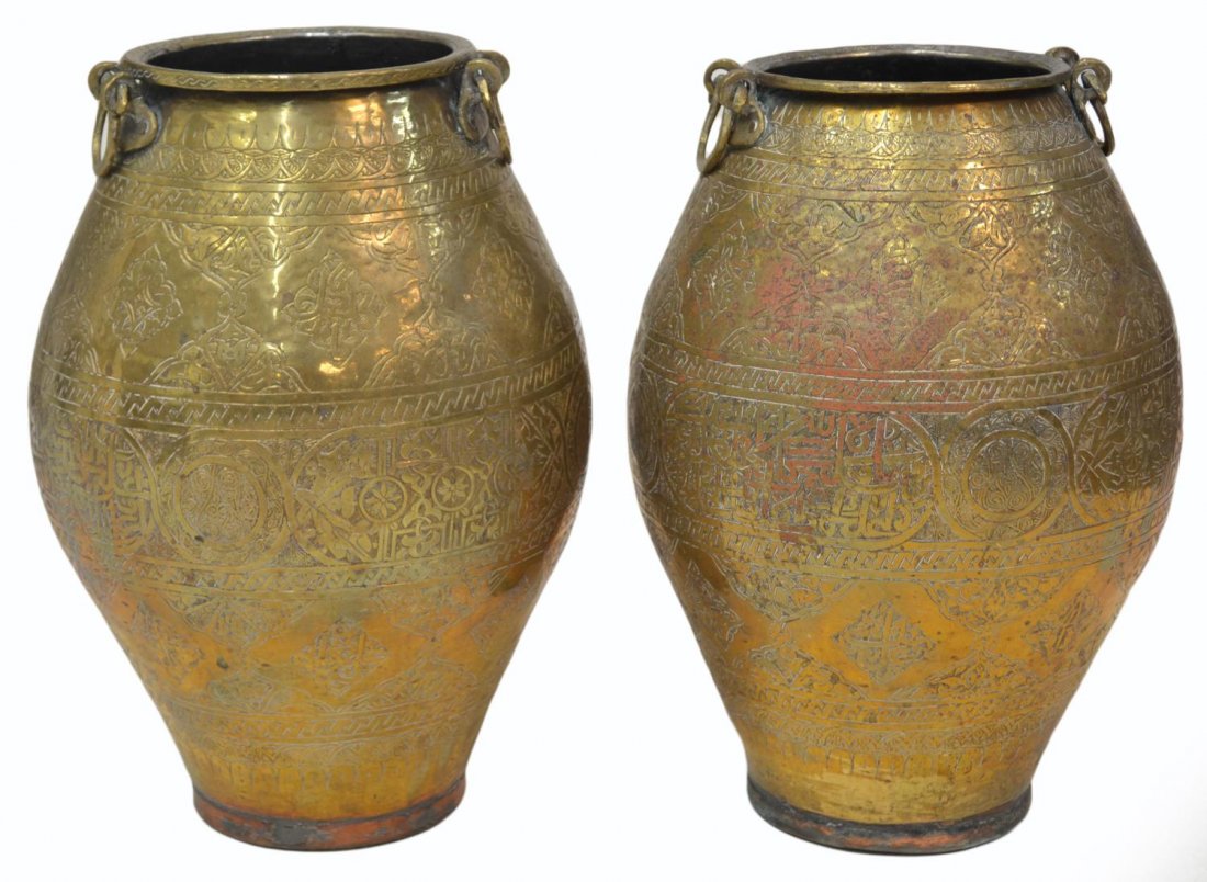 (2) VINTAGE MIDDLE EASTERN ARABESQUE METAL URNS: (pair) Middle Eastern gilt metal urns, each in an arabesque motif with diminutive hook handles 15.5"h, 11lbs total *Provenance: The estate of Douglas B. Marshall (1917-2007) and his wife, Margaret Cul