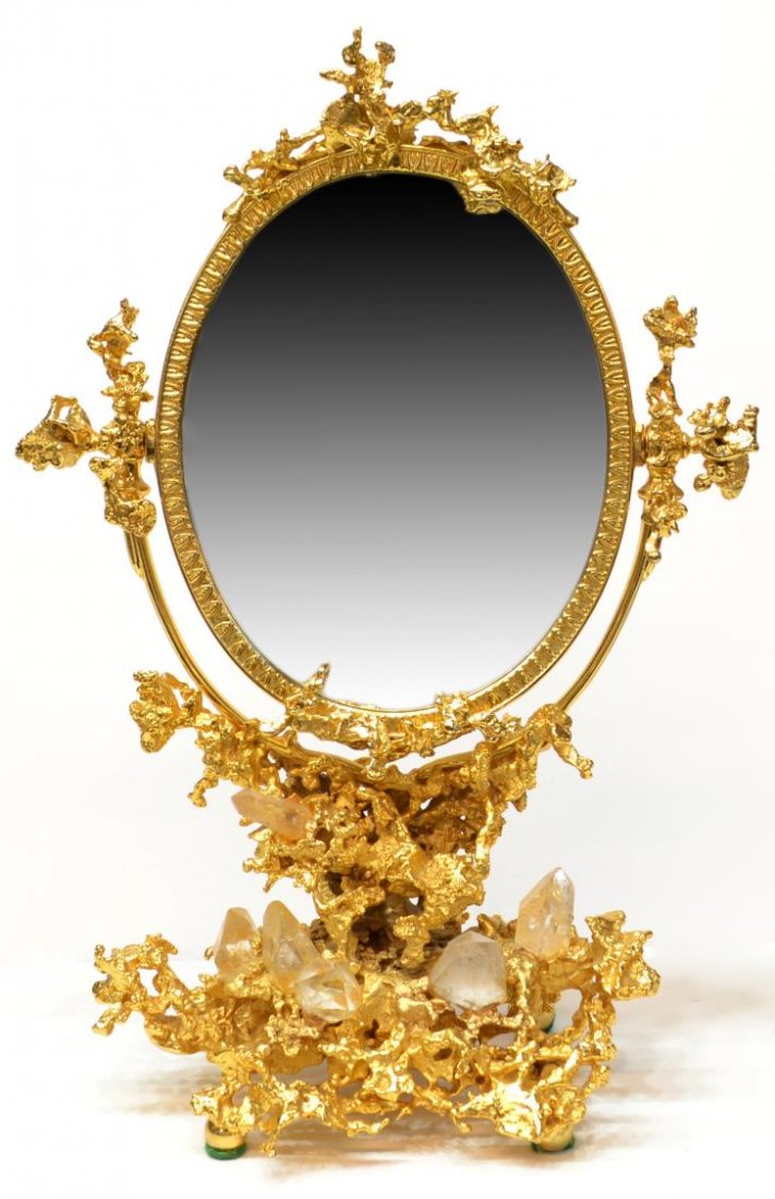 PARIS GILT BRONZE MIRROR, CLAUDE VICTOR BOELTZ: French gill bronze table mirror, by Claude Victor Boeltz (France, b. 1937), an oval mirror tilting on the abstract frame, encrusted with crystal formations, on small ball feet, signed verso Boeltz, Pa