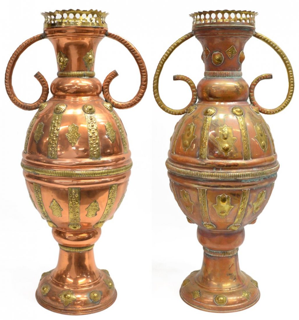(2)LARGE MIDDLE EASTERN BRASS COPPER FLOOR URNS: (pair) Middle Eastern handled copper floor urns having applied brass decor, the Hand of Fatima spaced by hammered strips, weighted base, 27.5"h, 28lbs total *Provenance: The estate of Douglas B. Marsh