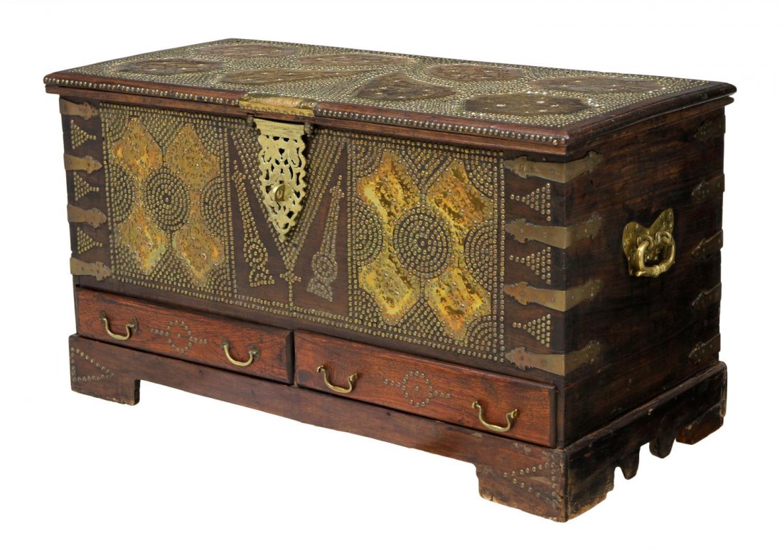 MOROCCAN BRASS NAILHEAD HARDWOOD STORAGE CHEST: Iron bound oak storage chest, Morocco, applied to the top and face with ornamental brass sheets and nail head accents, interior storage, above two drawers, raised on a bracket base, side carrying hand