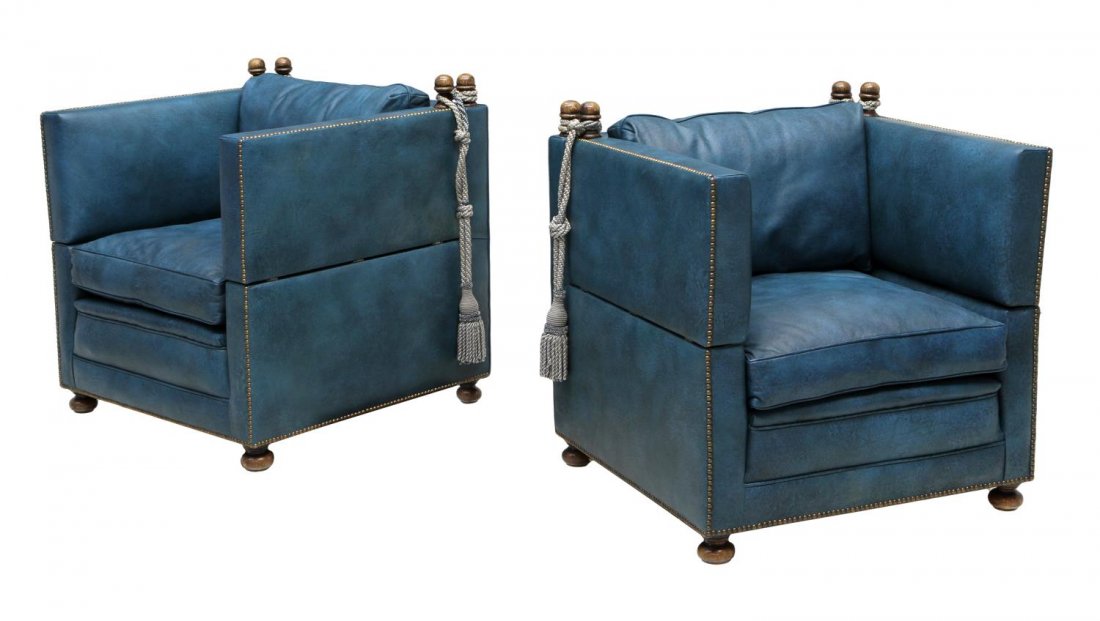 (2) SPANISH DROP SIDE LEATHER CHAIRS: (lot of 2) Spanish cushioned chairs upholstered in blue leather, removable ties at corners secured to mounted finials allowing the ends to drop, resting on bun feet, 33"h, 30.75"w, 30.5"d *Provenance: