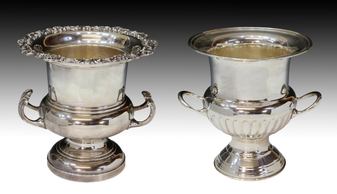 (2) SILVERPLATE CHAMPAGNE COOLERS / ICE BUCKETS: (lot of 2) Silver plate champagne coolers: (1) FB Rogers, the flared rim a raised vine of flowering foliates, handled body on a pedestal foot, 9.75"h, 9.75"diam (top); handled bucket on tall foot, Ind