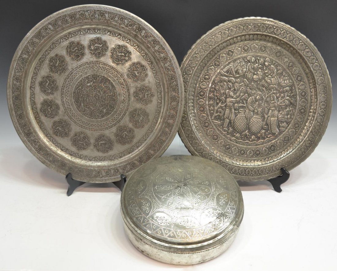 (3) GROUP OF PERSIAN METAL CHARGERS & CIRCULAR BOX: (lot of 3) Collection of Persian metalware, Kerman, comprising: (1) incised charger, reserves of animals enclosing central reserve of foliage and birds, foliated border, 19.5"diam; (1) repousse charge