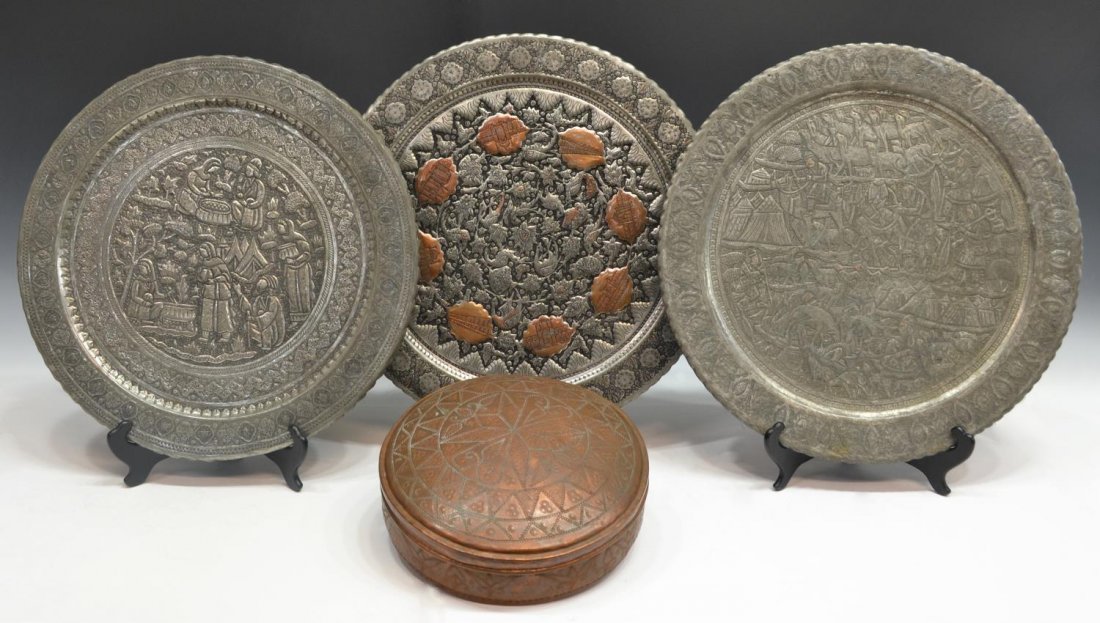 (4) PERSIAN INCISED & REPOUSSE CHARGERS & BOX: (lot of 4) Collection of Persian metalware, Kerman, comprising: (2) incised and repousse chargers, central wells depicting figural scenes enclosed by stylized foliate borders, largest: 19.5"diam; (1) 