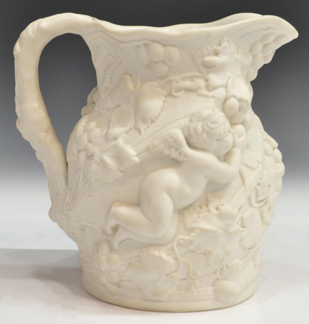 CONTINENTAL PARIAN PUTTI & GRAPE RELIEF PITCHER: Continental molded relief parian pitcher, winged putti surrounded by grape clusters and climbing vines, minor hairline to interior, 8"h, 8"w (including handle), 2.5lbs Start Price: $60.00