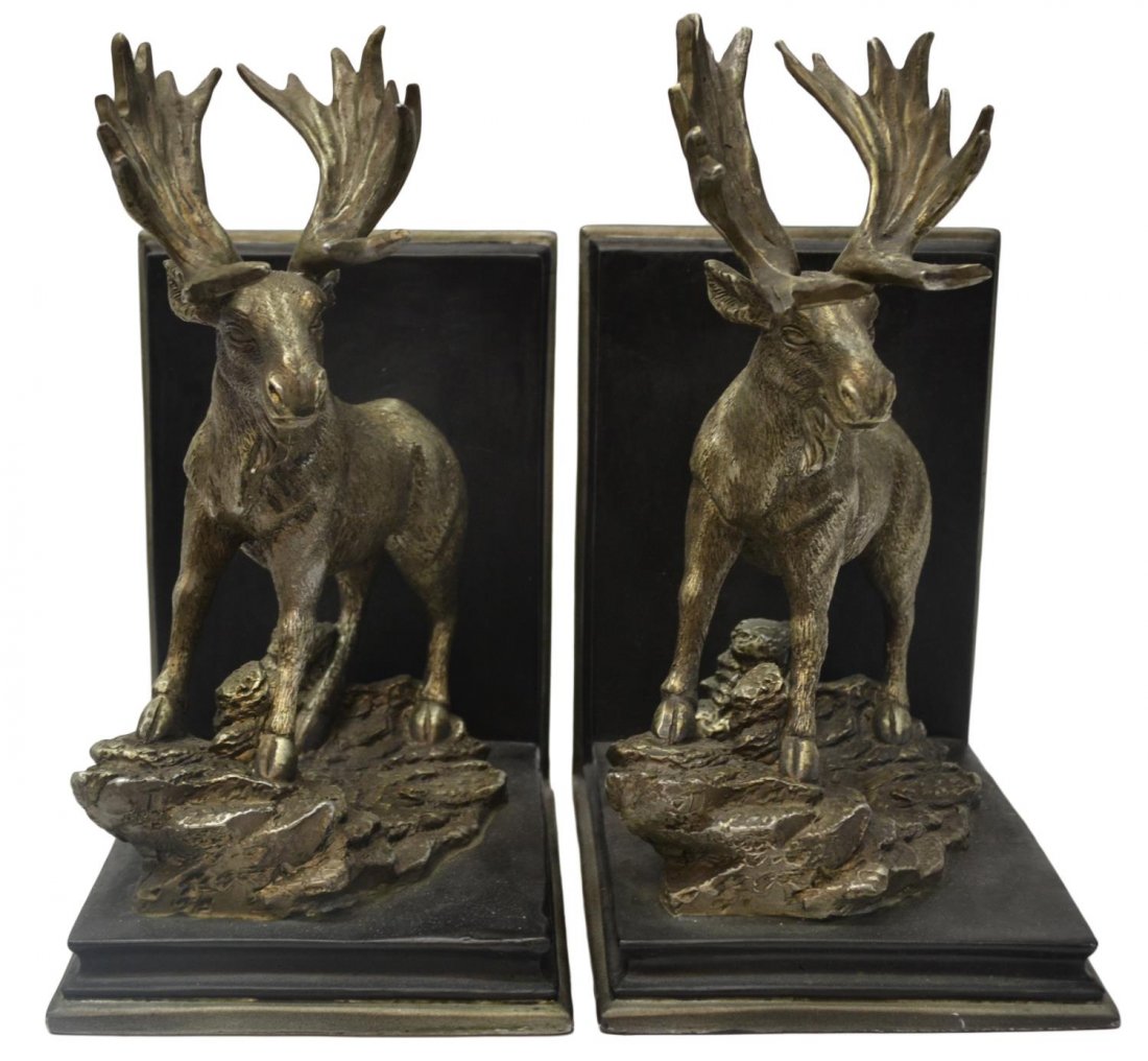 (PAIR) DECORATIVE MOOSE BOOK ENDS: (pair) Decorative wood and composite book ends, each mounted with a silver toned moose on a naturally carved rock base, restoration to one horn, 9"h, 4.75"w, 6.25"d, 7.25lbs total Start Price: $40.00