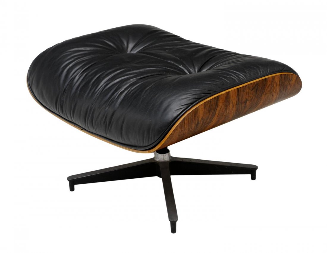 EAMES FOR HERMAN MILLER MODERN OTTOMAN: Charles and Ray Eames designed ottoman (#671) for Herman Miller, Zeeland, Michigan, 1980, black buttoned leather upholstery, rosewood shell frame, retaining Miller tags at underside, 16"h, 26"w, 21"d 