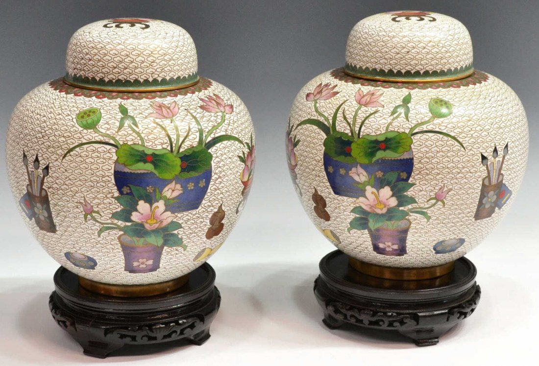 (PAIR) LARGE CLOISONNE ENAMEL LIDDED GINGER JARS: (pair) Large Chinese cloisonne enamel covered jars, each white ground densely patterned with cloud wirework, bright polychrome enamels of flowering plants, peaches and artist brushes, jar: 9"h, on pie
