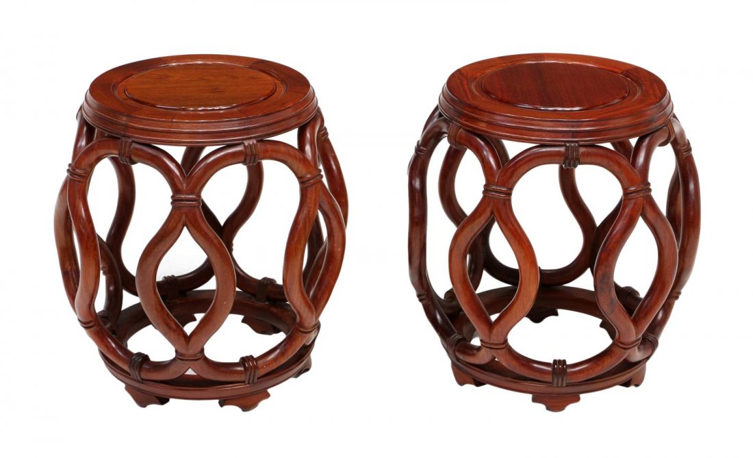 (PAIR) CHINESE CARVED ROSEWOOD DRUM-FORM STOOLS: (pair) Chinese rosewood stools, each of drum shape having a circular top above curved openwork design, circular base raised on short feet, approx 18"h, 15.5"diam Start Price: $150.00