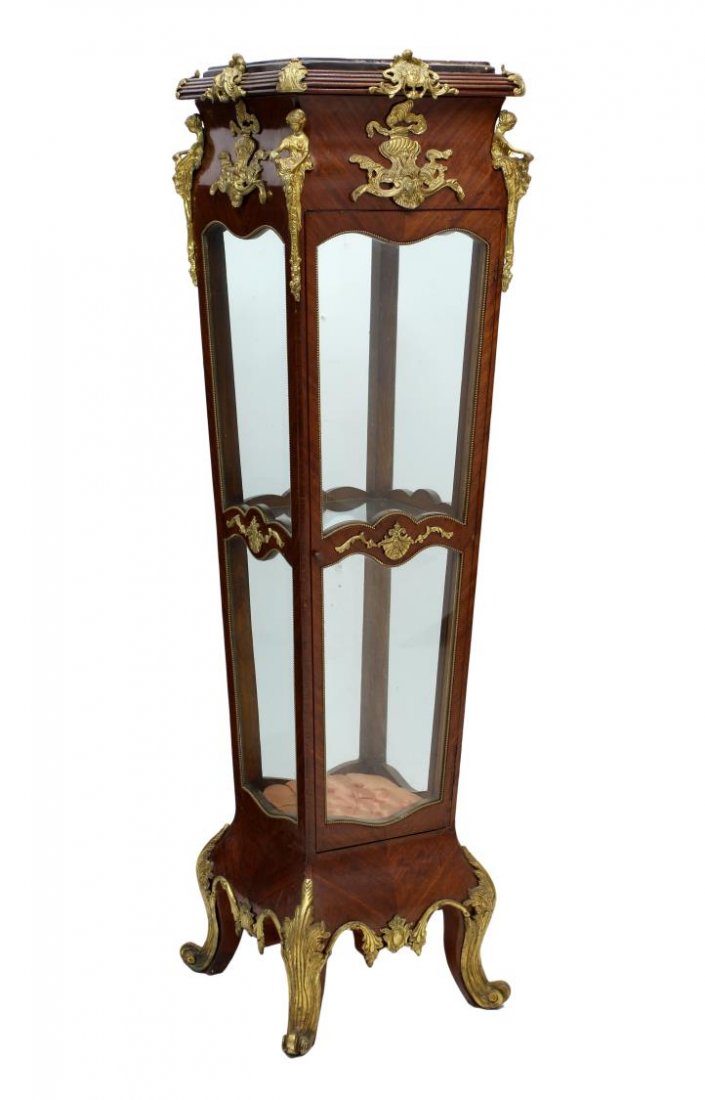 LOUIS XV STYLE MARBLE TOP VITRINE STAND: Louis XV style vitrine stand, 20th c., decorated with foliate and figural gilt metal, a marble top over the single door four sided glass display case rising on scrolled feet, 65"h, 18"w, 18"d **Proven