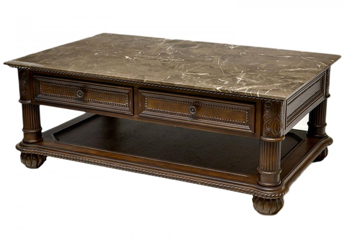 MARBLE TOP & CARVED WOOD COFFEE TABLE: Marble top coffee table, dark brown marble with white flecks over two frieze drawers, rising on ribbed leg corner supports joined by lower shelf, set on melon feet, 21'h, 52"w, 31.5"d Start Price: $40