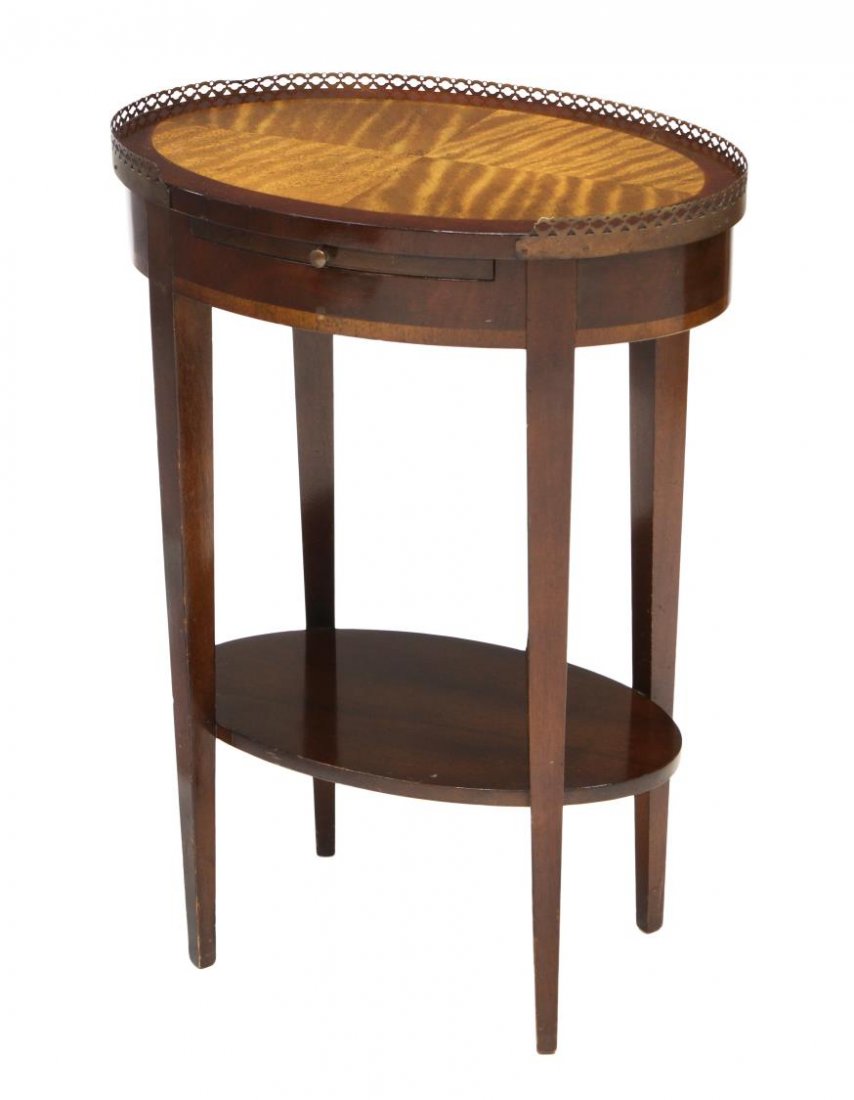 DIMINUTIVE ENGLISH STYLE INLAID OCCASIONAL TABLE: Diminutive English style occasional table, 20th c., the oval top having matched inlay with a short pierced grill over a pull out tray, all rising on four tapered square legs joined by a lower shelf, 2