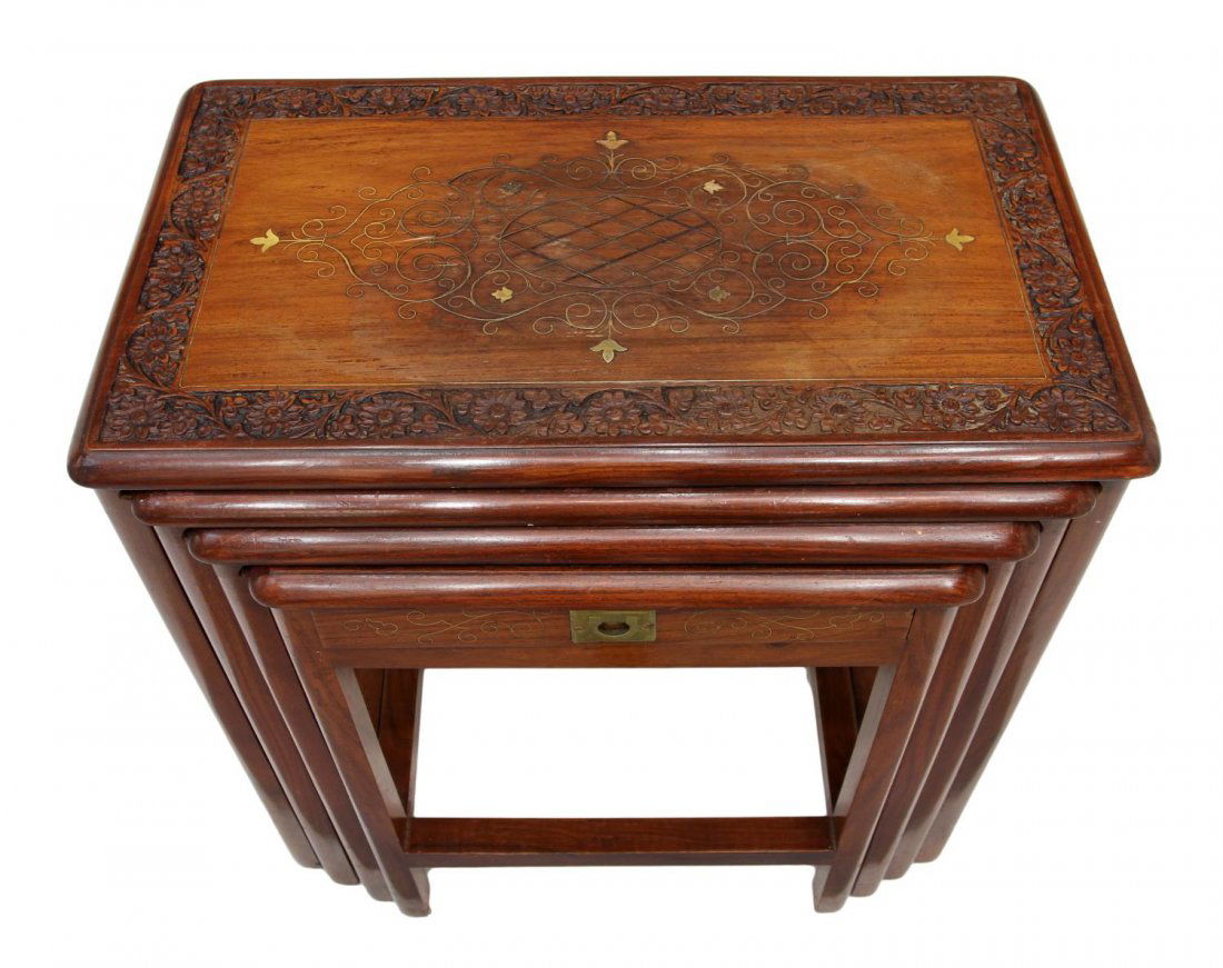(4) NEST OF FOUR FOLIATED BRASS INLAID TABLES: (lot of 4) Nesting tables, likely India, rectangular with floral carved borders enclosing scrolled foliate gilt brass inlays, the smallest with a frieze drawer, stretcher joined square legs, largest: