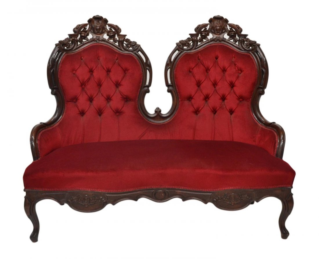 ANTIQUE ROCOCO CARVED TUFTED SOFA: Victorian style upholstered sofa, early 20th c., in the Rococo manner, floral carved and pierced crest over the ruby red buttoned back, rising on cabriole supports, 43"h, 24.5"w. 28"d Start Price: $30