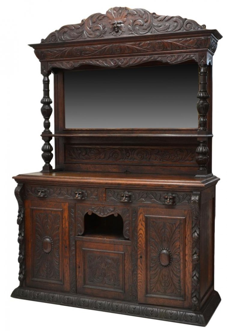 RENAISSANCE REVIVAL CARVED OAK SIDEBOARD: Renaissance Revival oak sideboard, c. 1900, carved profusely with foliage and flowers, a beveled mirror surmounted by figural crest and turned supports, two frieze drawers over an open shelf and three