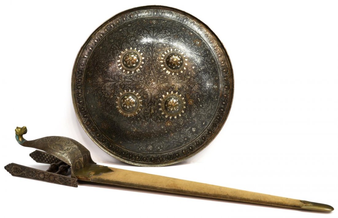 (2) FINELY DECORATED INDIA KATAR & DHAL SHIELD: (lot of 2) An India katar, 18th/19th c., decorated with foliate and mask koftgari etching, a double side 18.5"l blade with elaborate hand guard narrowing to a gilt bronze dragon mask flanked below by 