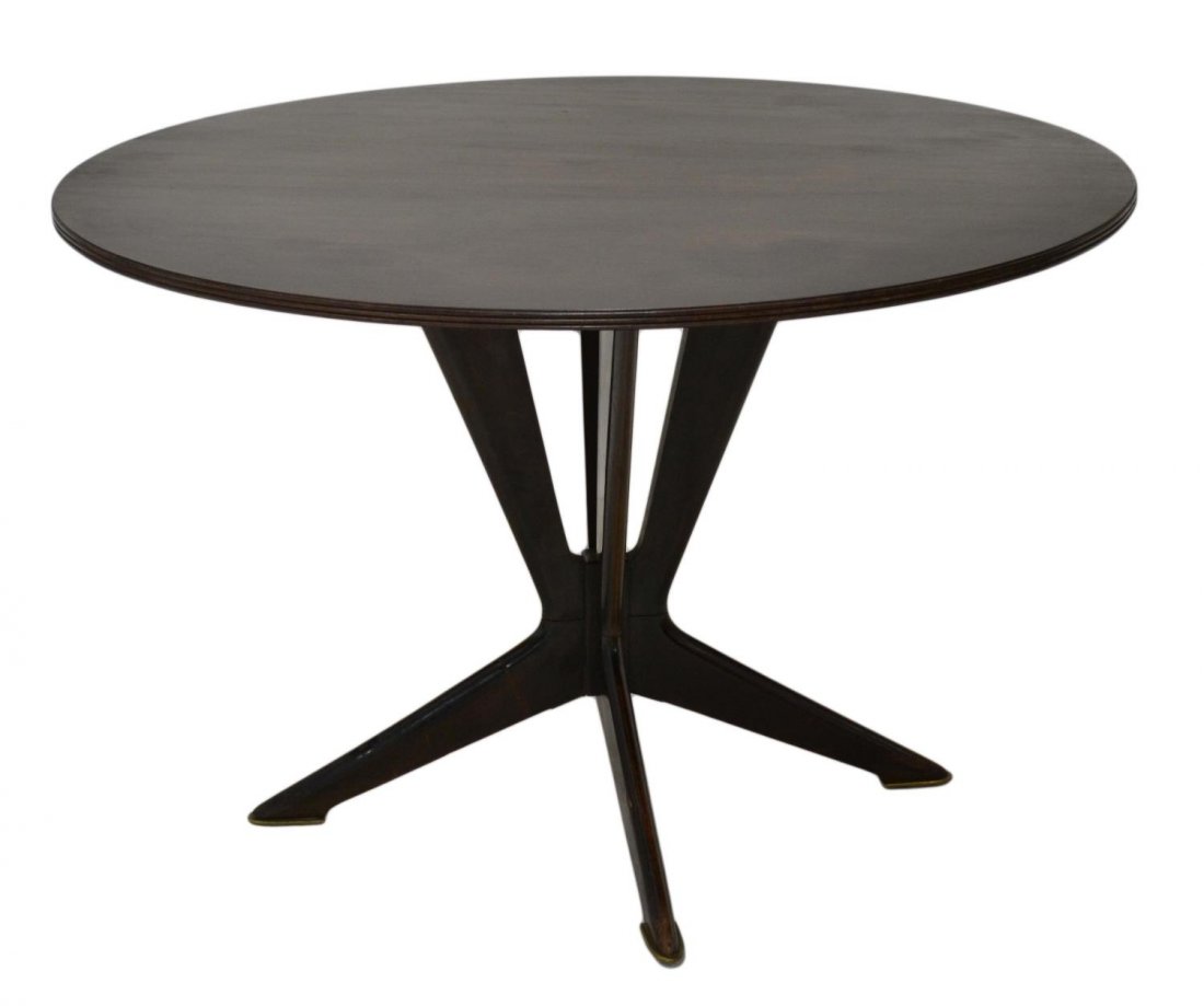 ITALIAN MID-CENTURY MODERN DINING TABLE, I. PARISI: Italian mid-century modern wood dining table, c. 1950, in the manner of Ico Parisi (Italian, 1919-1996), the circular top rising on tapered angular legs, surface wear to top, 30.25"h, 46.75"diam Start