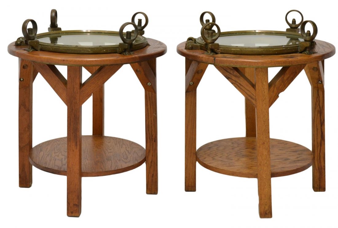 (2) VINTAGE BRASS SHIPS PORTHOLE SIDE TABLES: (pair) Vintage brass ship portholes, each inset into an oak frame forming a side table, over a medial shelf, rising on block supports, porthole: 21"diam, table: 28"h, 23.5"w Start Price: $300.00