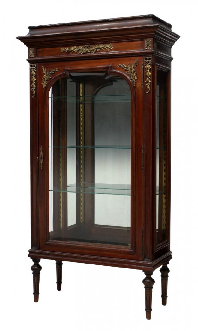 LOUIS XVI STYLE MAHOGANY VITRINE: Louis XVI style mahogany display cabinet, 20th c., a stepped cornice over the front shaped beveled glass door opens to a mirrored interior with adjustable glass shelves, rising on tapered ribbed legs 