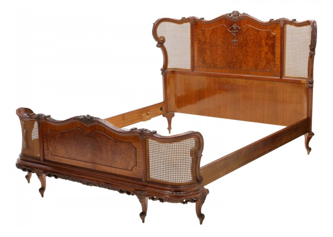 LOUIS XV STYLE MAHOGANY, BURL WOOD & CANE BED: Louis XV style mahogany and burl wood bed, Northern Spain, headboard centered with shell crest flanked by cane panels, overall with foliate carving, headboard: 51"h, 68"w, footboard: 27"h, 63.5"w, rai