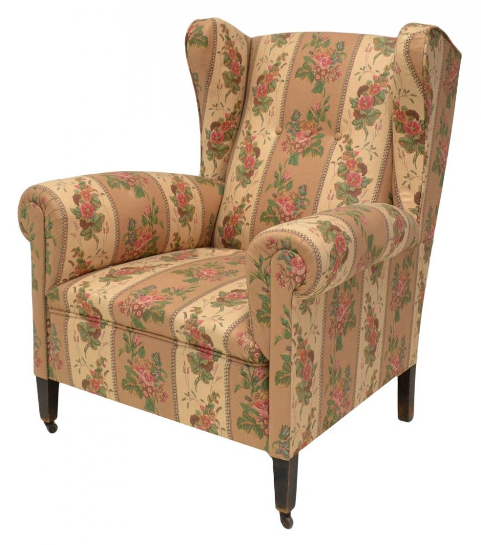 SPAIN FLORAL UPHOLSTERED WINGBACK ARM CHAIR: Spanish floral upholstered wingback arm chair, three buttoned back over seat, on tapered block supports terminating in castors, 42"h, 35.25"w, 33"d Start Price: $100.00