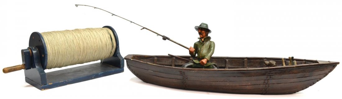 FISHING LINE DRYING RACK & DECORATIVE BOAT MODEL: (lot) Fishing items, comprising: (1) decorative model boat, with figure modeled as a man holding a metal fishing rod, accompanied by a wooden oar, seated dog and basket holding four fish, all as pictu