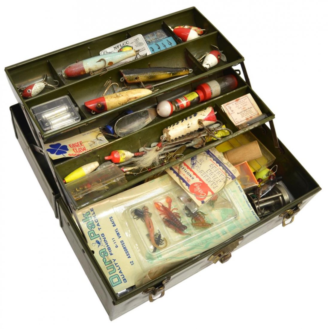 VINTAGE FISHING BOX PACKED FULL OF LURES & REELS: (lot) Vintage fishing tackle box with substantial quantity of lures and reels, highlights including Shakespeare 'Favorite 1733' Model 31 reel, Bomber Bait Co. lure, a fish scaler, lures, some with inl