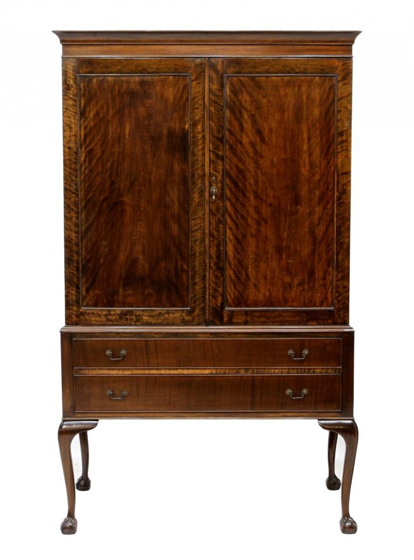 ENGLISH CHIPPENDALE STYLE LINEN PRESS, C. 1900: Chippendale style linen press on stand, c. 1900, two doors opening to shelves, two exterior drawers, the integral open stand rising on cabriolet legs with ball and claw feet, 71.25"h, 42.25"w, 23"d St