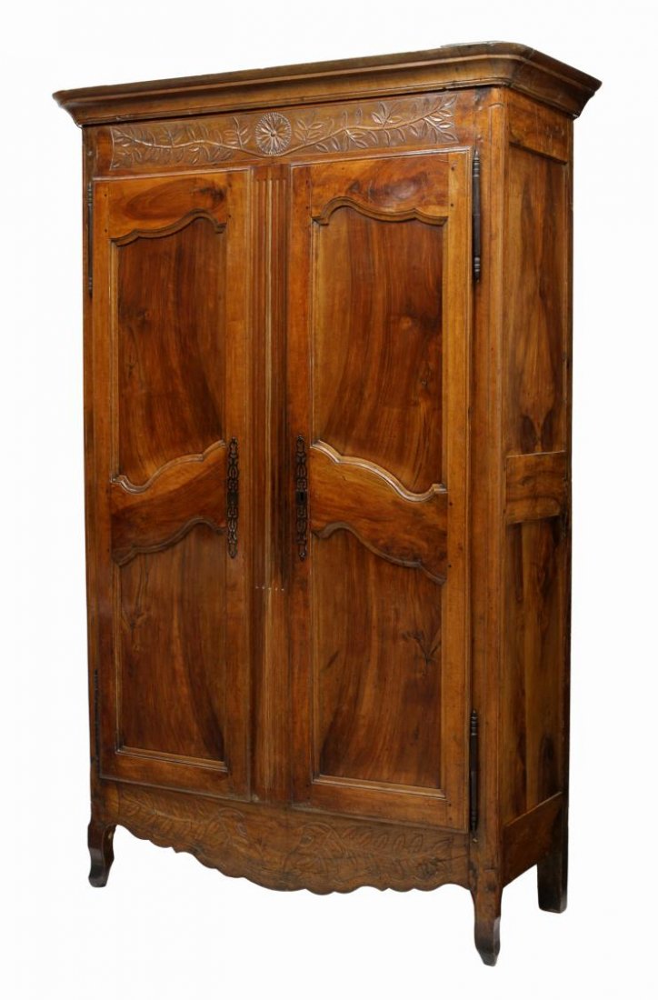 LOUIS XV STYLE CHERRY WOOD ARMOIRE, C. 1800: French Louis XV style cherrywood armoire, C. 1800, the stepped cornice over the foliate relief carved frieze, two doors opening to interior storage with shelf and three drawers, all rising on short ca