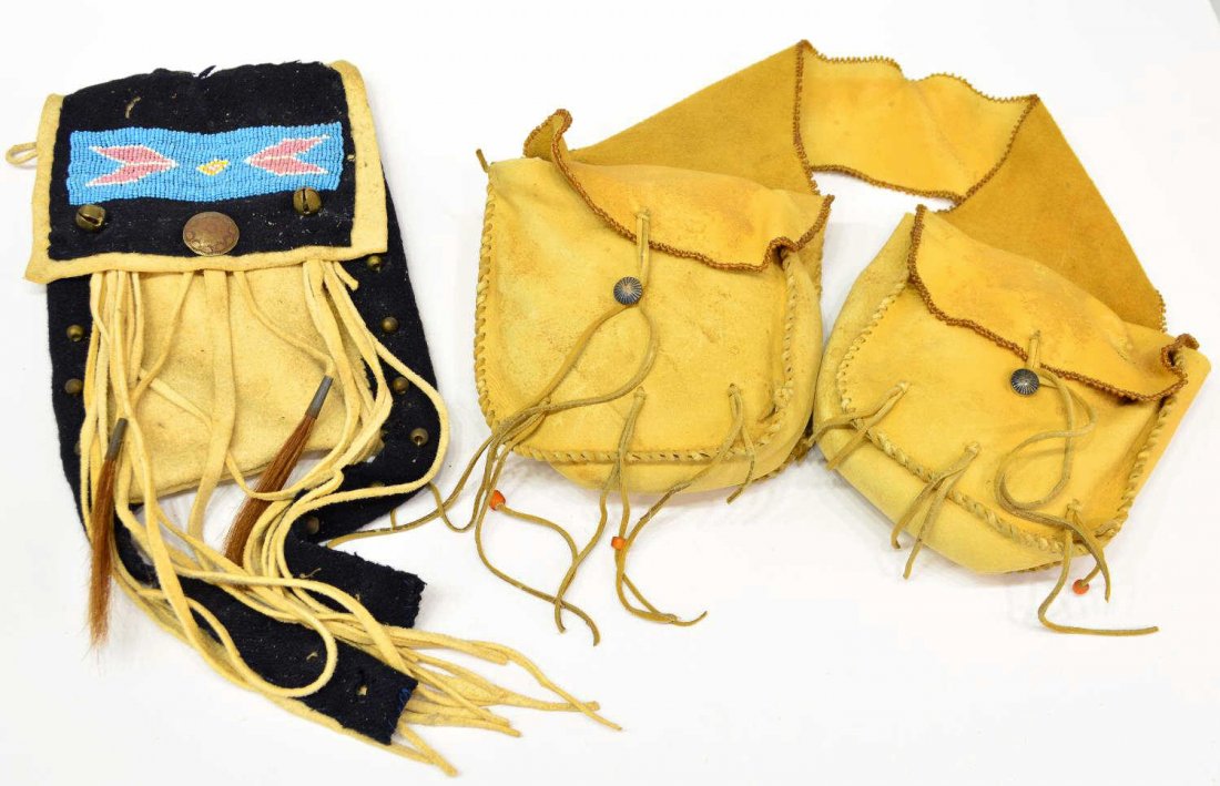 NATIVE AMERICAN BEADED BAG & LEATHER SADDLE BAGS: (lot of 2) Leather and beadwork bags: (1) Plains / Plateau fringed and beaded leather pouch, post WWII, 16"l; (1) Native American style leather saddle bags with Navajo silver buttons, post WWII, beade