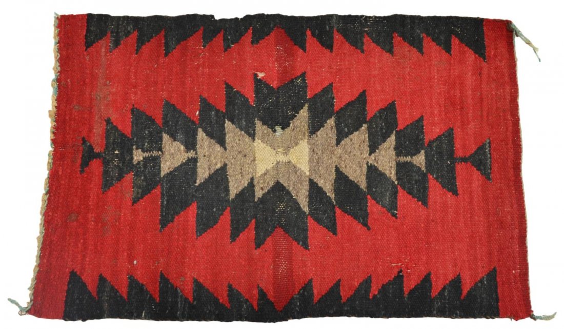 SOUTHWEST NATIVE AMERICAN WOVEN RUG: Navajo woven mat, an example of a 'Gallup throw', semi-antique, deep red ground with geometric pattern, some holes, open areas, approx 28.5"l, 18.5"w, .75lbs Start Price: $50.00