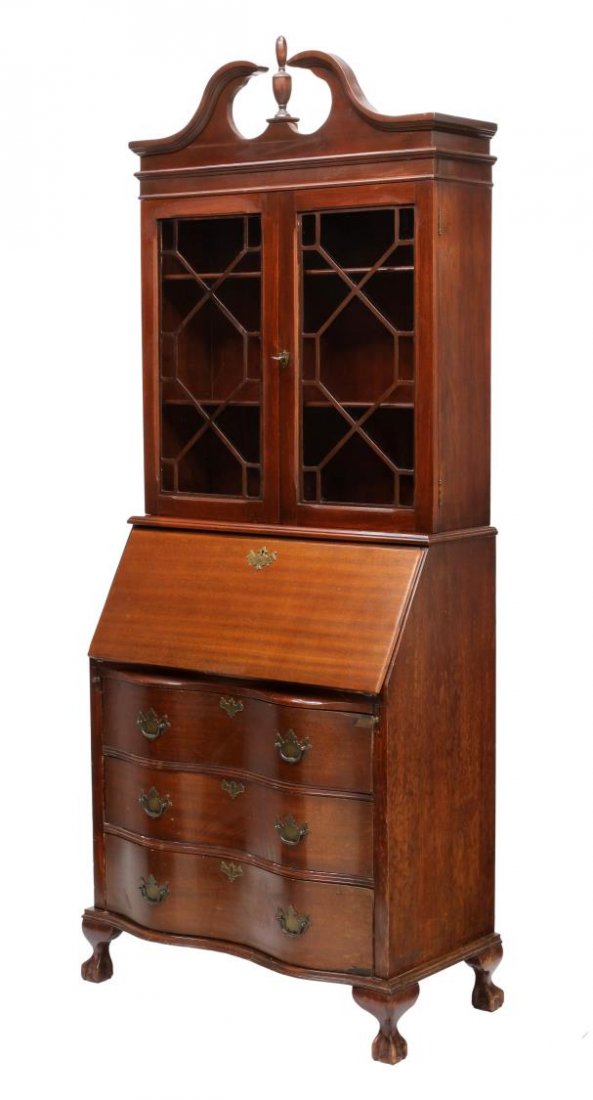 CHIPPENDALE STYLE SECRETARY BOOKCASE: Chippendale style secretary bookcase, a split pediment with finial over two astragal faced glazed doors, the slant lid opening to a fitted interior above three serpentine drawers, all raised on ball a